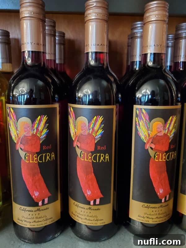 Red Electra California Moscato bottle, featuring a distinct red angel design, at Quady Winery.