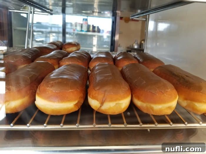 maple bars lined up in a bakery case