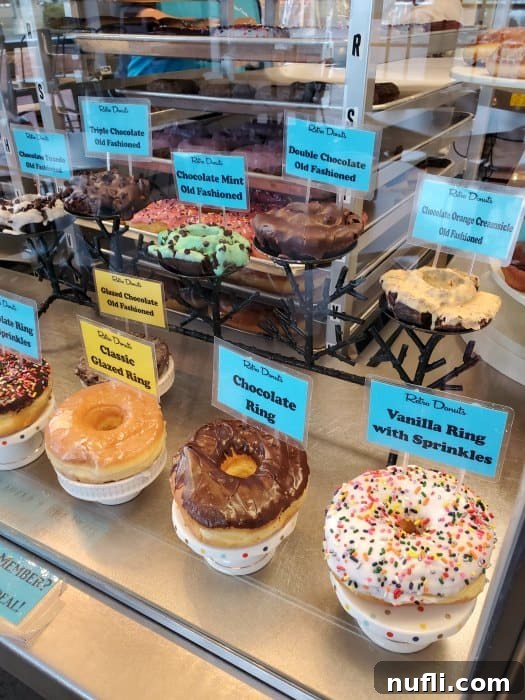 Donuts with blue signs displayed behind glass