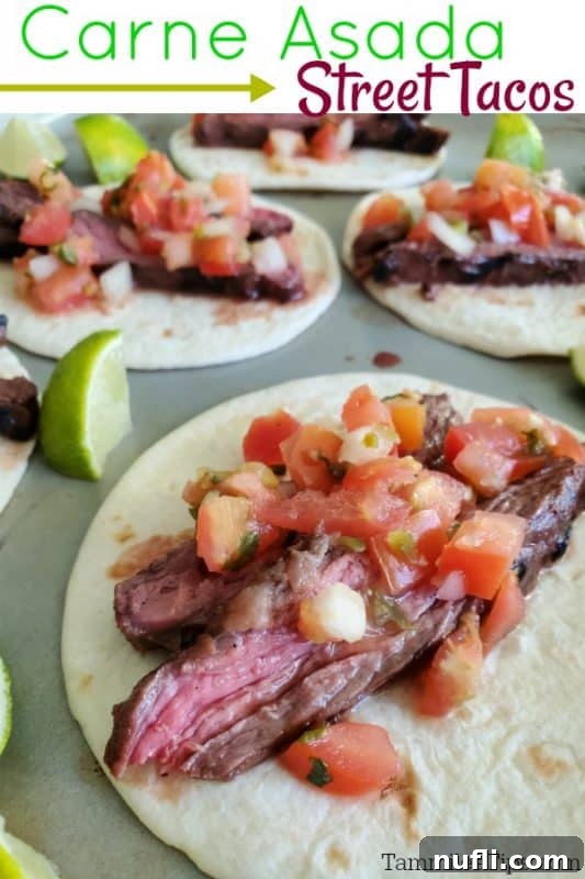 Ultimate Carne Asada Street Tacos 2 Carne Asada Street Tacos on a baking sheet with tacos and lime wedges, showcasing a vibrant Mexican meal.