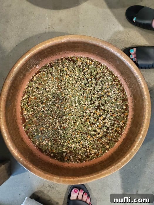 water in a copper bowl with feet standing next to it
