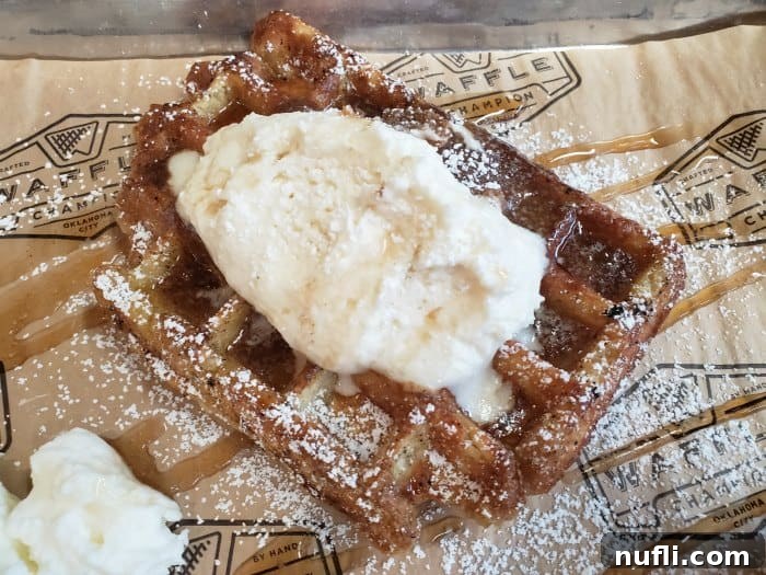 waffle covered in whipped cream and syrup 