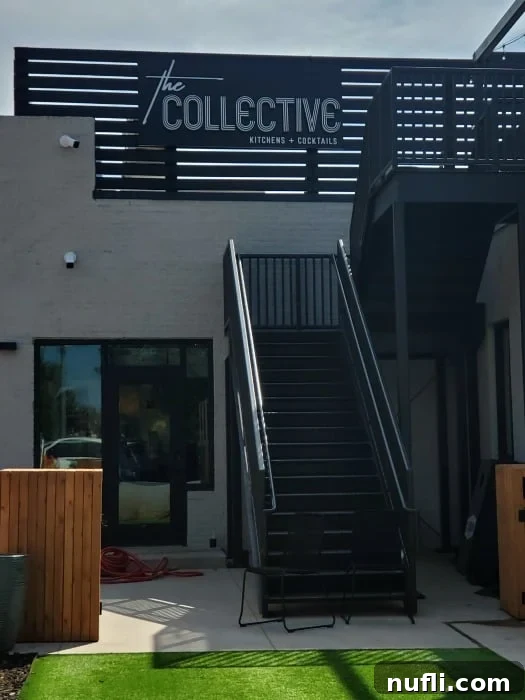 The Collective sign over a black stairwell on the side of a building 