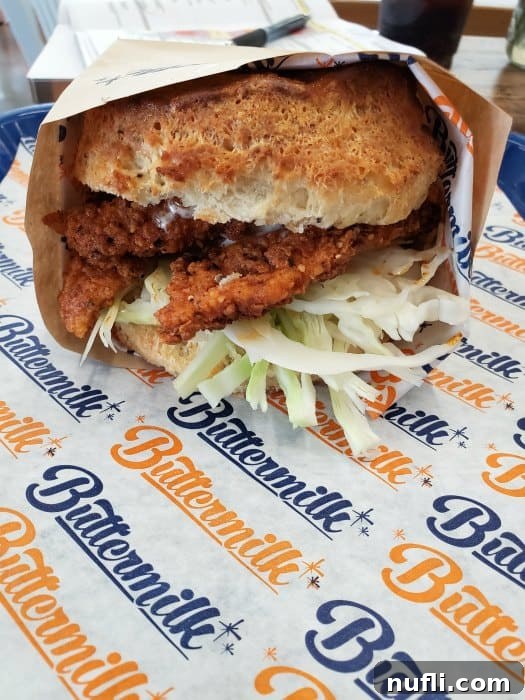 Buttermilk paper with a biscuit and chicken wrapped up 