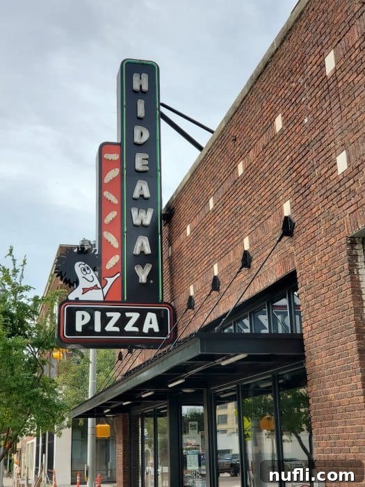 Hideaway Pizza sign on the side of a brick building 