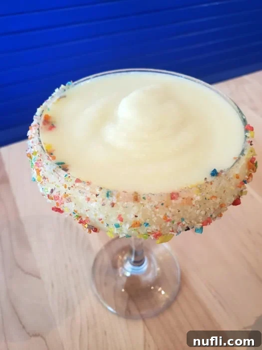 cocktail with fruity pebbles on the rim 
