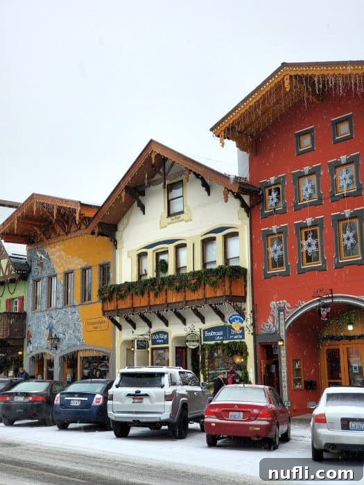 Leavenworth with snow on the ground, Christmas lights hanging from the buildings
