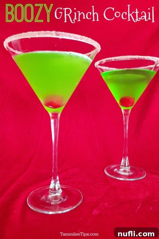 Boozy grinch cocktail over two green martinis on a red background, showcasing a festive holiday drink.