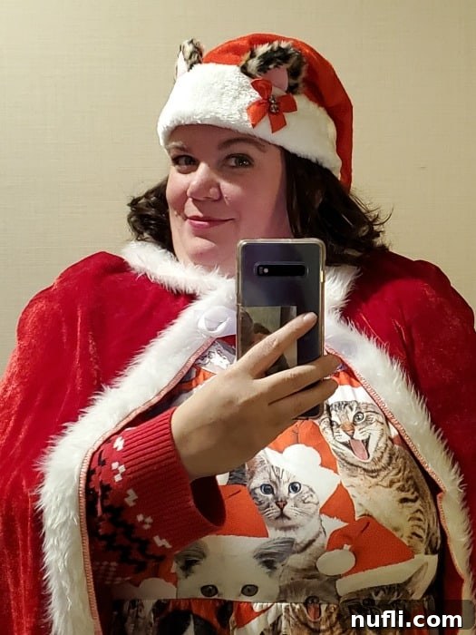 Tammilee dressed in a charming kitten Santa dress, embodying the festive spirit.