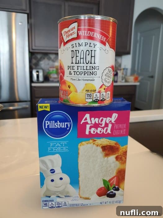 A can of peach pie filling positioned next to a box of angel food cake mix, ready for baking.
