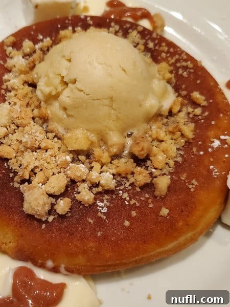 pancakes with toppings on a white plate