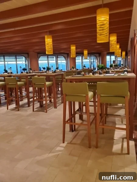 indoor seating with tall tables and lanterns hanging form the ceiling