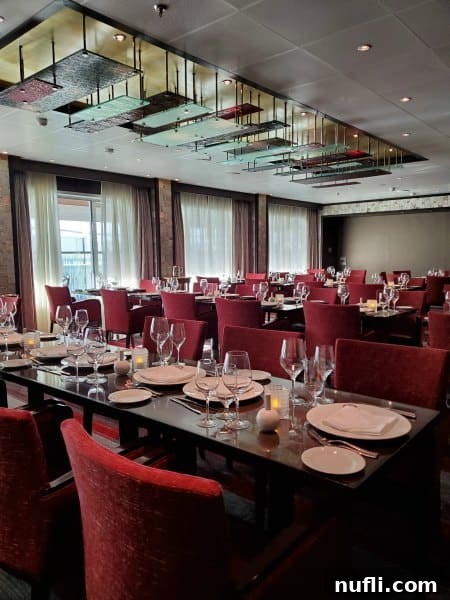 Fahrenheit 555 indoor seating with fancy place settings and red chairs