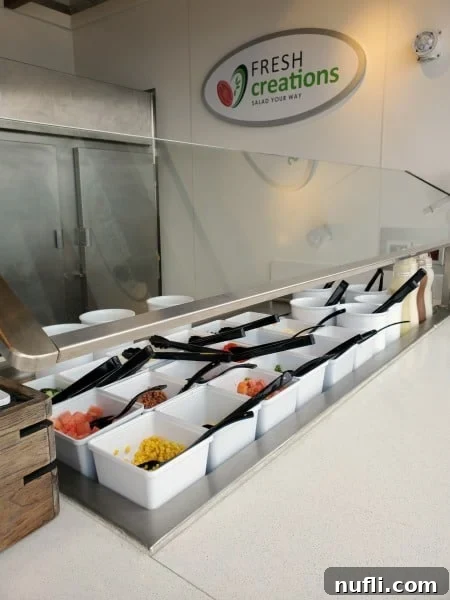 fresh creations sign over a salad bar