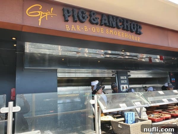 Guy's pig & anchor barb-b-que smokehouse sign over a counter top filled with meat