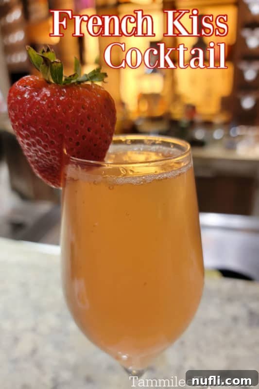 Carnival Alchemy Bar: The Signature French Kiss Cocktail 2 French Kiss Cocktail over a champagne flute with a strawberry garnish