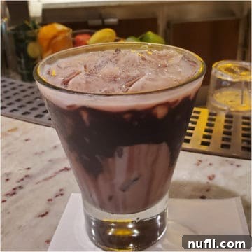 Chocolate drizzled glass with Deal Closer Cocktail ingredients ready to be mixed