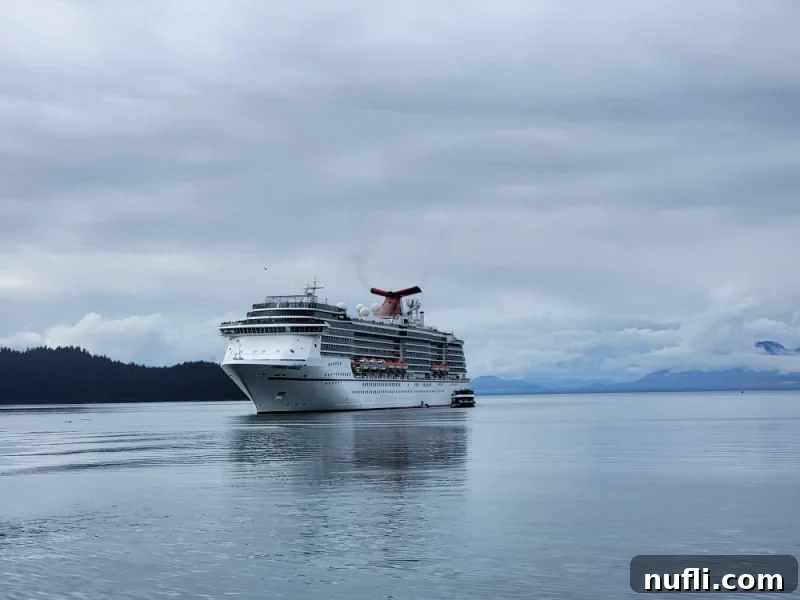 Everything You Need to Know About the Carnival Cheers Package 8 Carnival Cruise ship with clouds and mountains behind it in alaska