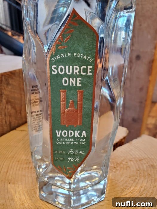 Close up of Bentley Heritage Source One Vodka bottle on a wood platform