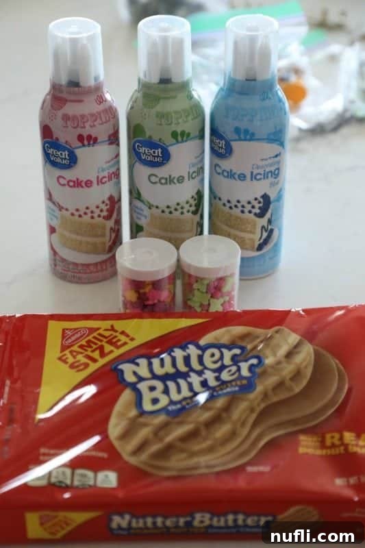 Cake icing cans, sprinkles, and a package of Nutter Butter on a counter, ready for decorating