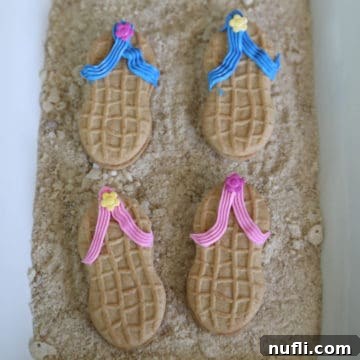 Flip Flop Nutter Butters on edible sand on a white platter
