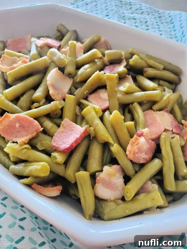 green beans and bacon in a white serving dish