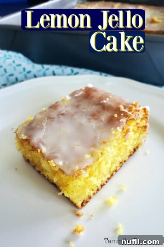 Zesty Lemon Jello Cake Recipe 2 Lemon jello cake over a square of cake on a white plate