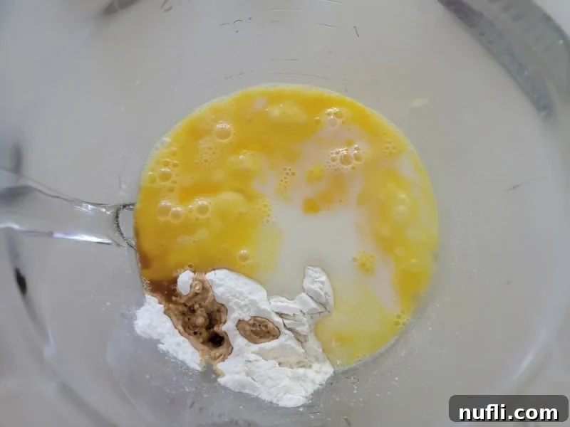 Easy German Apple Pancakes 6 German Apple Pancake batter in a glass bowl