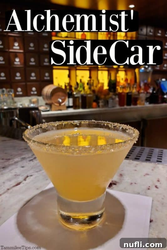 Alchemist Sidecar cocktail served in a short martini glass, resting on a white napkin at a bar, showcasing its elegant presentation.