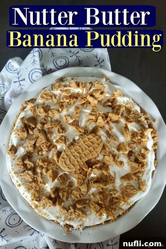 A beautiful Nutter Butter banana pudding pie, garnished with whipped cream and crushed Nutter Butter cookies, ready to be served.