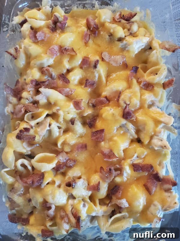 chicken bacon ranch casserole covered in melted cheese in a casserole dish