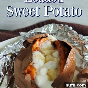 Texas Roadhouse loaded sweet potato wrapped in foil, garnished with golden mini marshmallows.