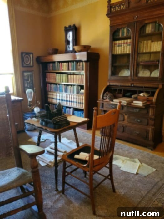 John muir office with table, typewriter, bookshelves, and shelves of books