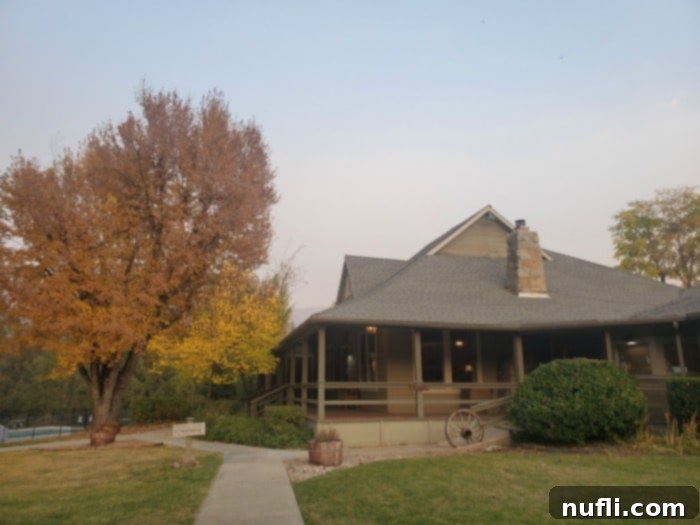 Sierra Sky Ranch entrance with a wagon wheel and fall leaves on the trees