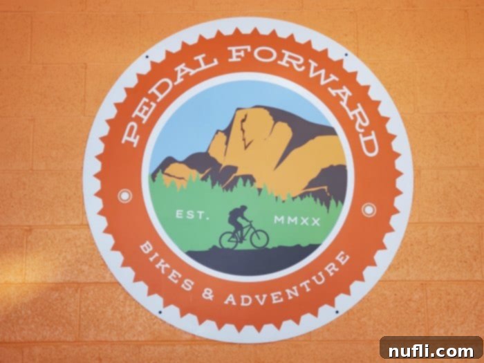 Pedal Forward Bike Shop sign with a biker on it
