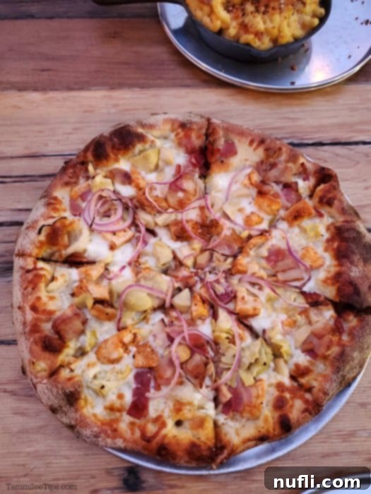 Pizza with garlic and red onions on a table 