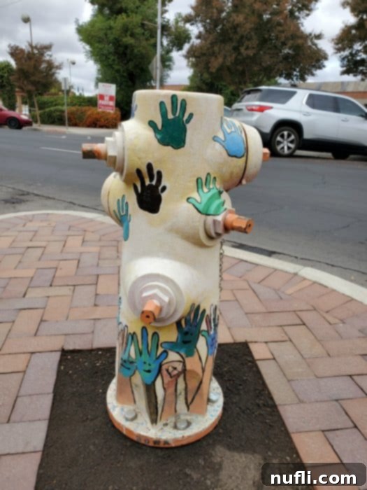 fire hydrant painted with hands all over it 