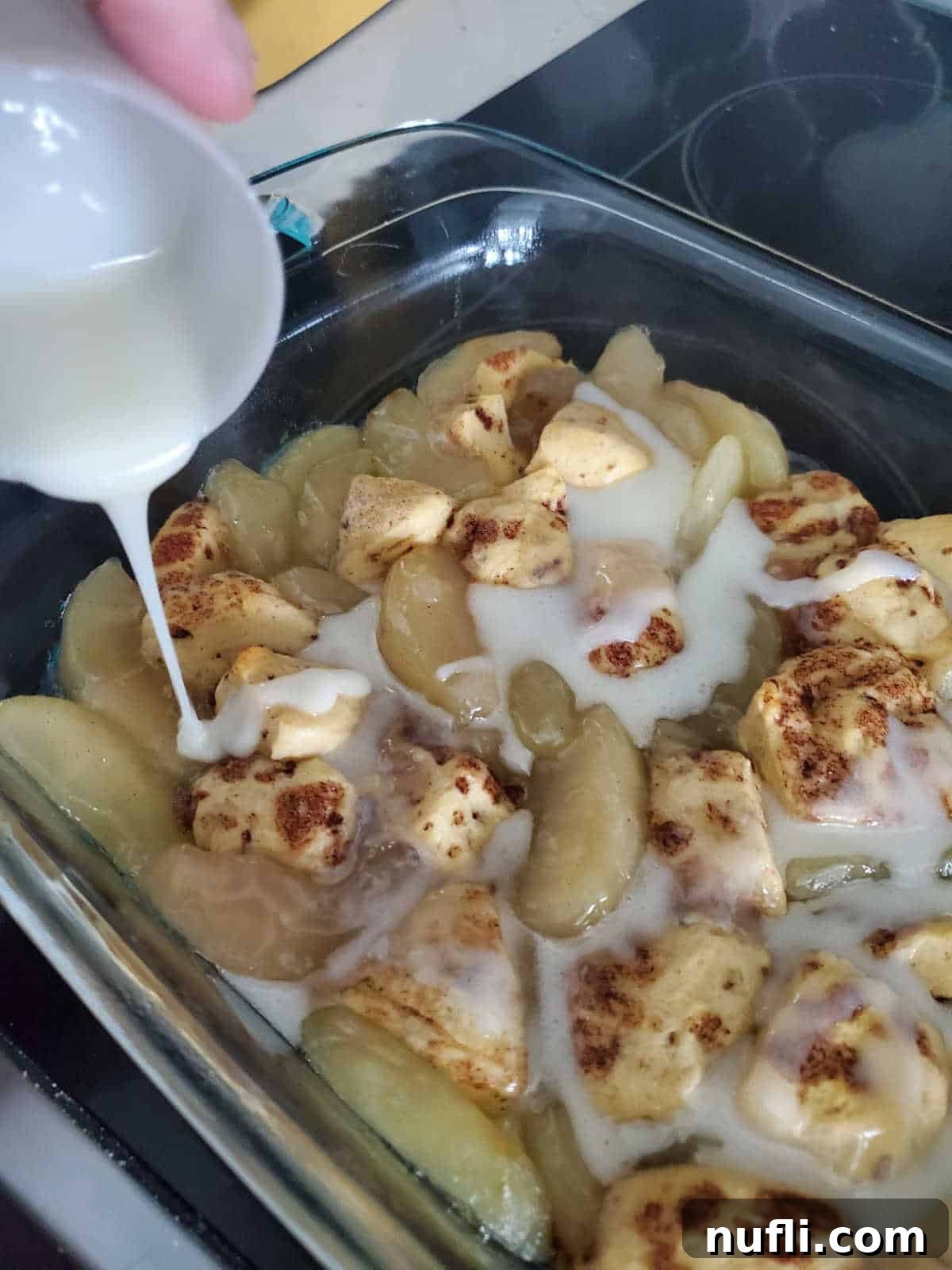 Cinnamon Roll Apple Pie Bake 6 icing pouring over cinnamon roll and apple pieces