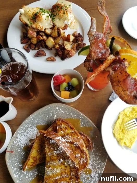 french toast, bloody mary, and eggs benedict on a table