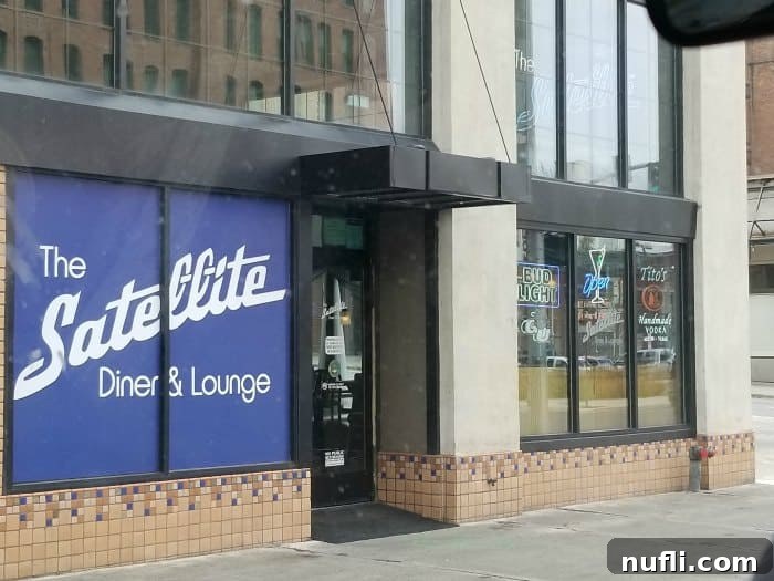 The Satellite diner and lounge sign on the side of a building