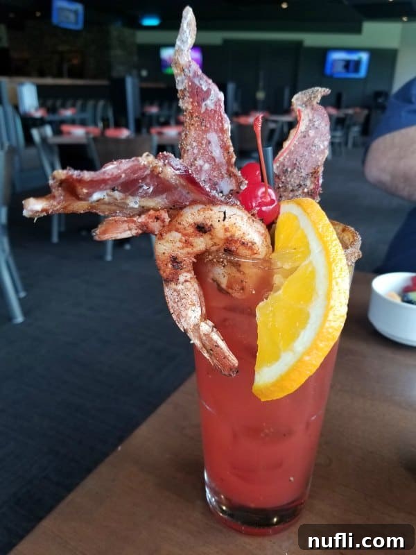bloody mary with shrimp and bacon on table