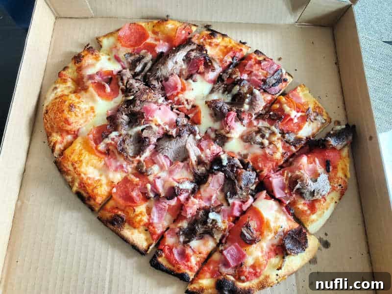 Spokane's Top Pizza Spots 12 pepperoni, bacon, and prime rib on a pizza in a delivery box