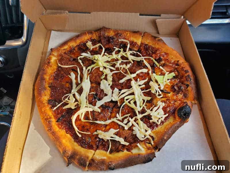 Spokane's Top Pizza Spots 18 Pizza in a cardboard delivery box