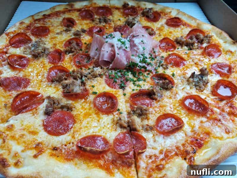 Spokane's Top Pizza Spots 20 pepperoni and prosciutto on a pizza with cheese in a cardboard delivery box