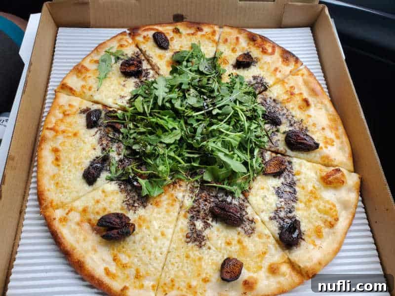 Spokane's Top Pizza Spots 21 figs, arugula, and cheese on a pizza in a cardboard delivery box