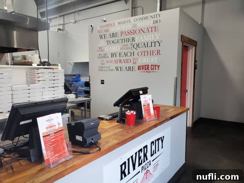 Spokane's Top Pizza Spots 23 River city pizza sign on a counter with cash registers