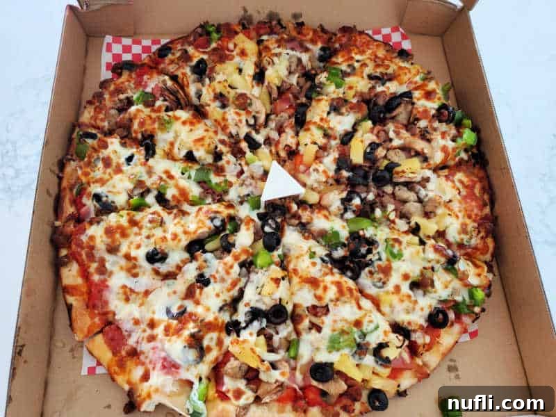 Spokane's Top Pizza Spots 30 Pizza with cheese, pepperoni, black olives and more in a cardboard delivery box