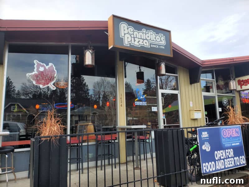Spokane's Top Pizza Spots 4 Exterior of Benniditos Pizza with glass windows and a fence leading to the door