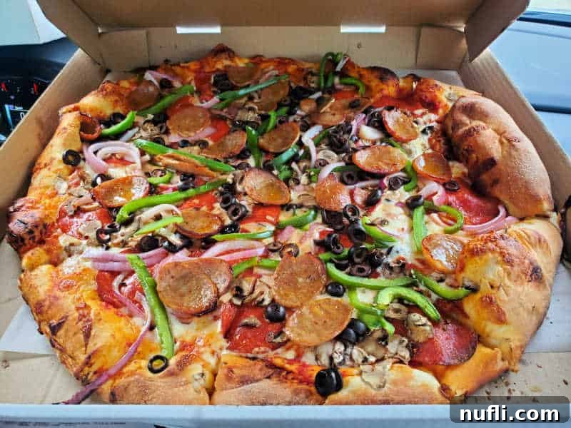 Spokane's Top Pizza Spots 5 Pizza in a box with mushrooms, olives, peppers, pepperoni, and onions