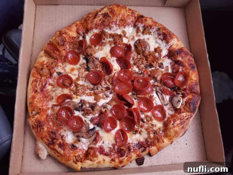 Spokane's Top Pizza Spots 9 Pepperoni and sausage pizza in a cardboard delivery box